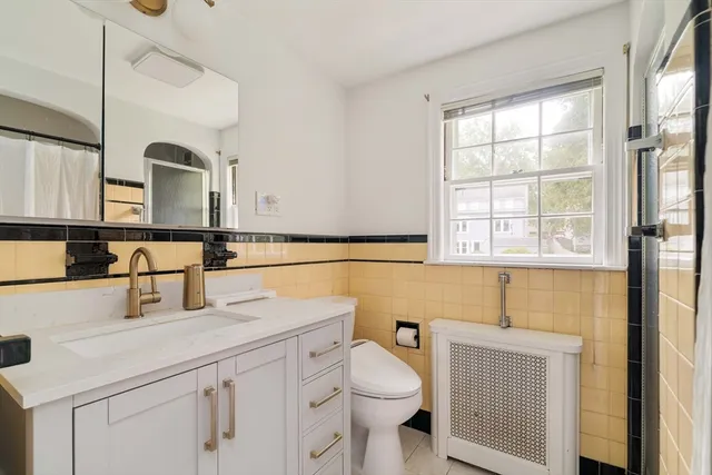 a bathroom with a sink a toilet and mirror