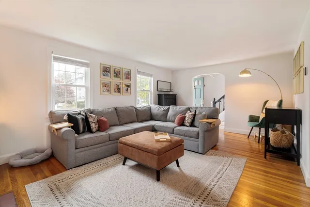 a living room with furniture a rug and a window