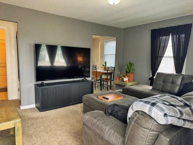 557-28 28 3/4 Road Grand Junction, CO 81501 - Photo 4 of 19 a living room with couches a flat screen tv and a large window