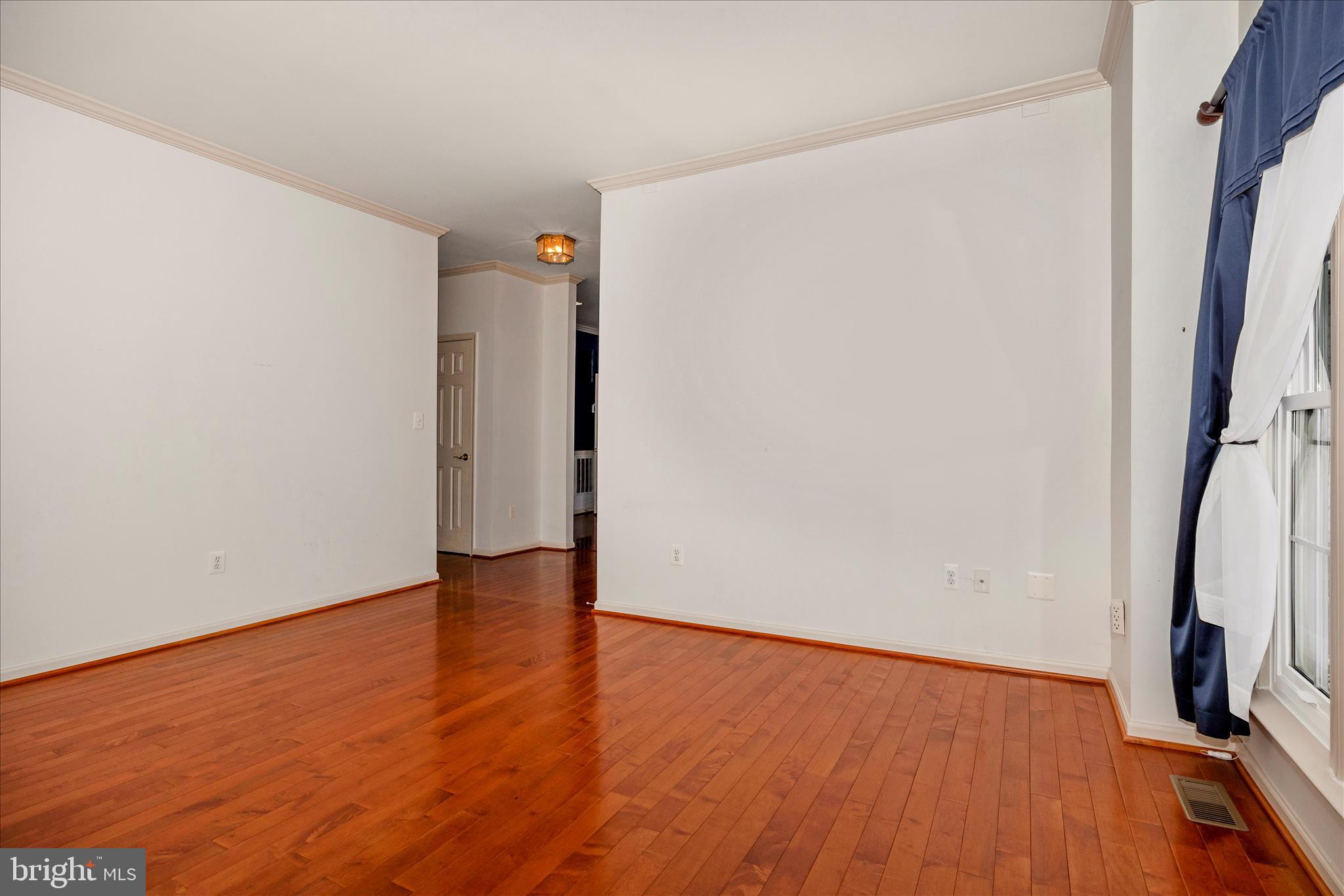 828 Geronimo Drive Frederick, MD 21701 - Photo 18 of 64 a view of an empty room with wooden floor and a window