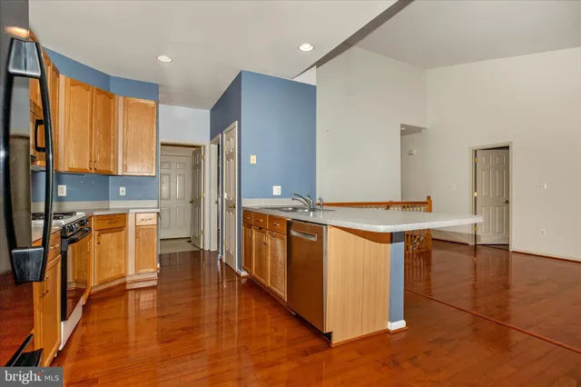 a view of kitchen with counter top space and refrigerator