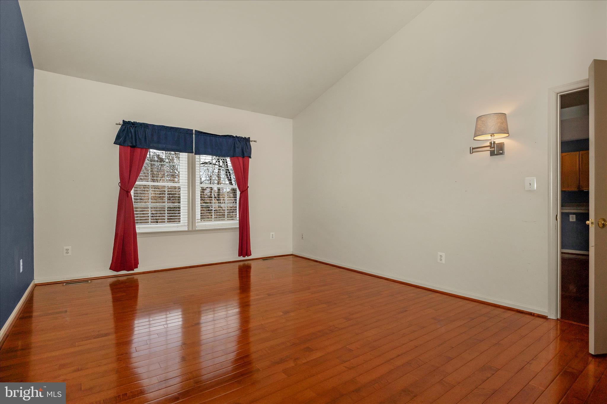 828 Geronimo Drive Frederick, MD 21701 - Photo 31 of 64 a view of an empty room with wooden floor and a window