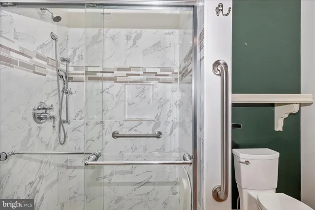a view of front door with wooden floor and stairs