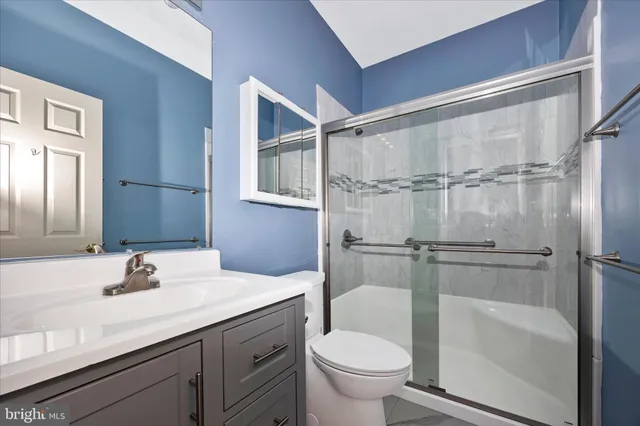 a view of a room with a ceiling fan and a window