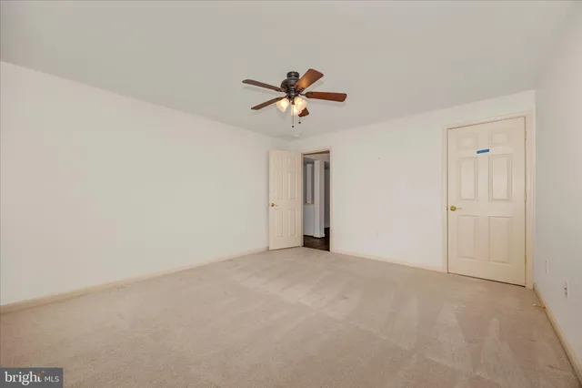 a view of a white house with a snow in yard