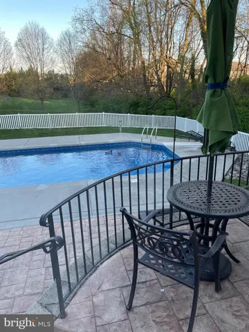 a view of backyard with deck and outdoor seating