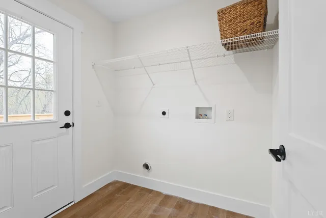 a view of a room with wooden floor and windows