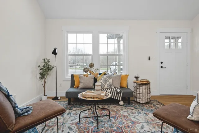 a living room with furniture and wooden floor