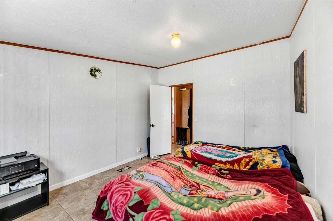 214 The Ranch Road Del Valle, TX 78617 - Photo 15 of 40 a bedroom with a bed and a window