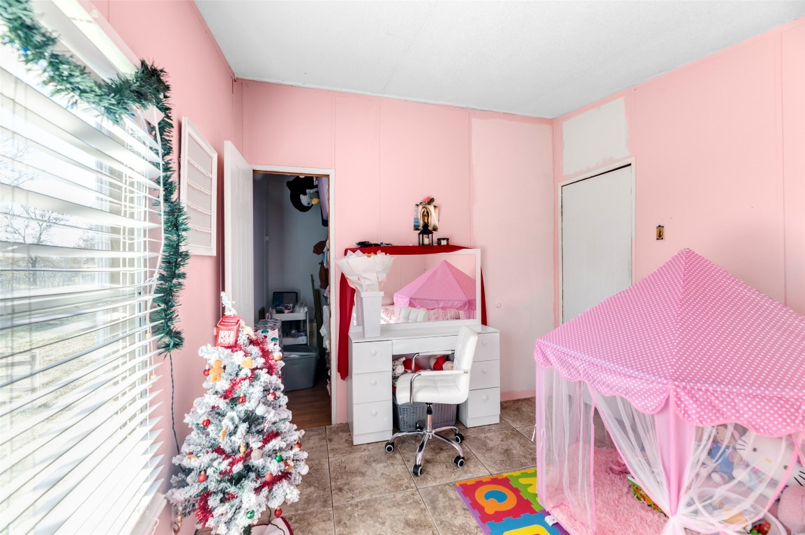 214 The Ranch Road Del Valle, TX 78617 - Photo 18 of 40 a bed room with a bed and a couch