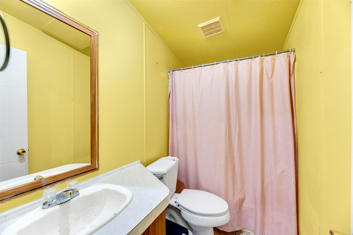 214 The Ranch Road Del Valle, TX 78617 - Photo 19 of 40 a bathroom with a sink and toilet