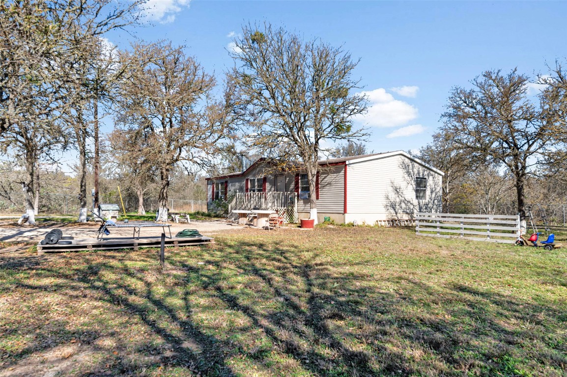 214 The Ranch Road Del Valle, TX 78617 - Photo 28 of 40 a view of a yard with a house in the background