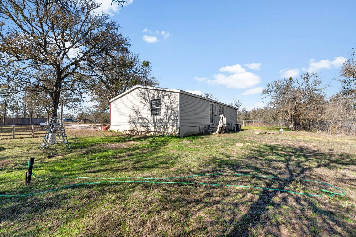 214 The Ranch Road Del Valle, TX 78617 - Photo 29 of 40 a view of back yard of the house