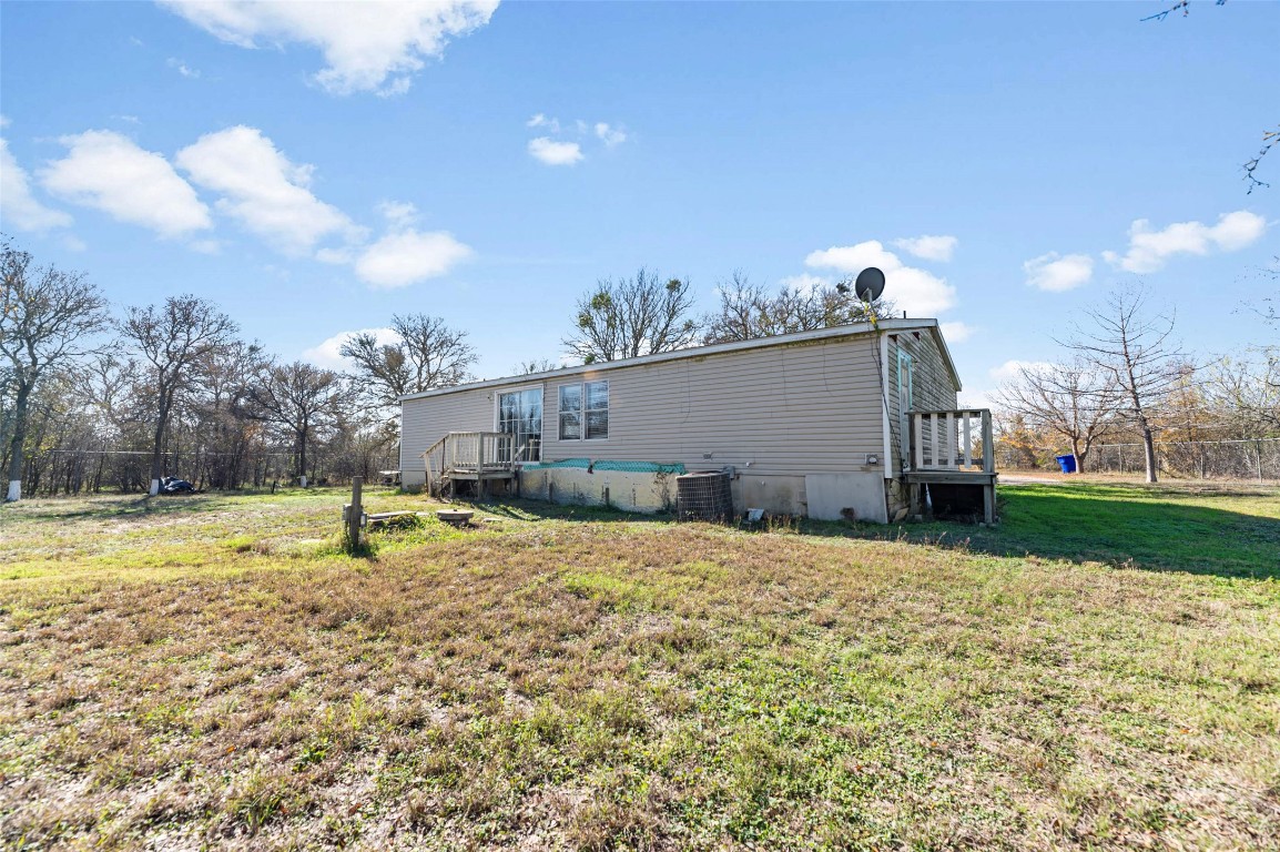 214 The Ranch Road Del Valle, TX 78617 - Photo 34 of 40 a swimming pool with yard in front of it