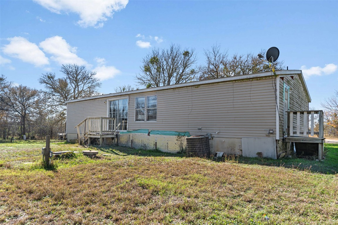 214 The Ranch Road Del Valle, TX 78617 - Photo 35 of 40 a backyard of a house with table and chairs