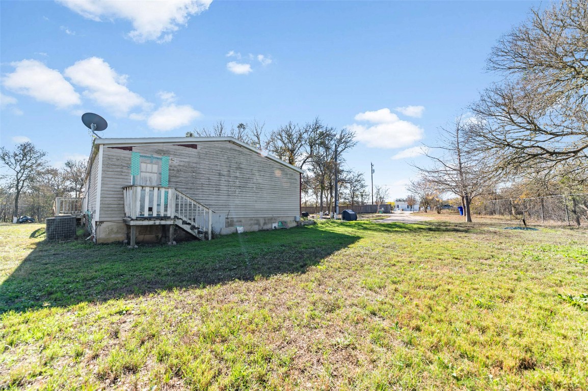 214 The Ranch Road Del Valle, TX 78617 - Photo 38 of 40 a view of a house with a yard