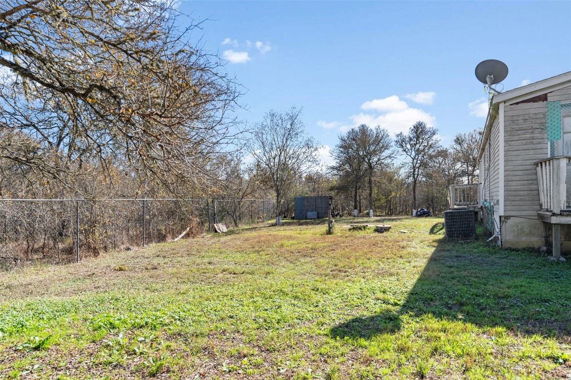 214 The Ranch Road Del Valle, TX 78617 - Photo 39 of 40 a view of a backyard with large trees