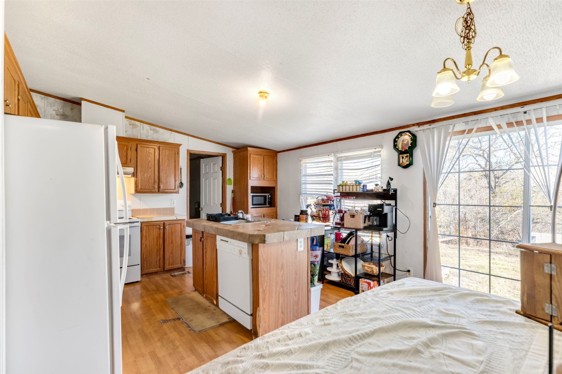 214 The Ranch Road Del Valle, TX 78617 - Photo 10 of 40 a kitchen with stainless steel appliances kitchen island granite countertop a refrigerator and a stove top oven