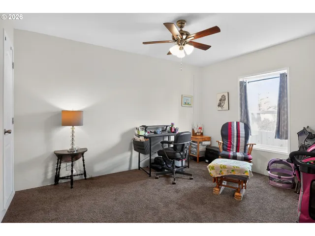a living room with furniture a window and a chandelier