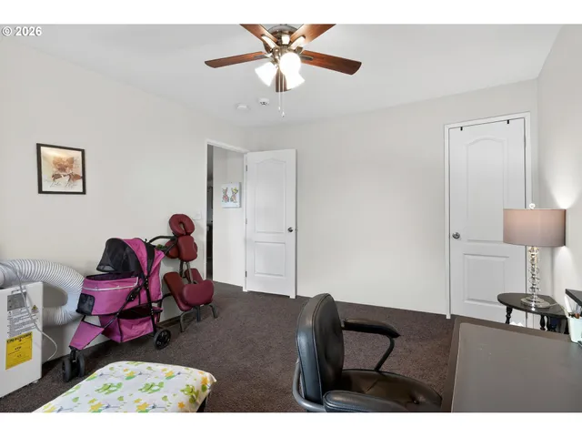 a bedroom with furniture and a rug