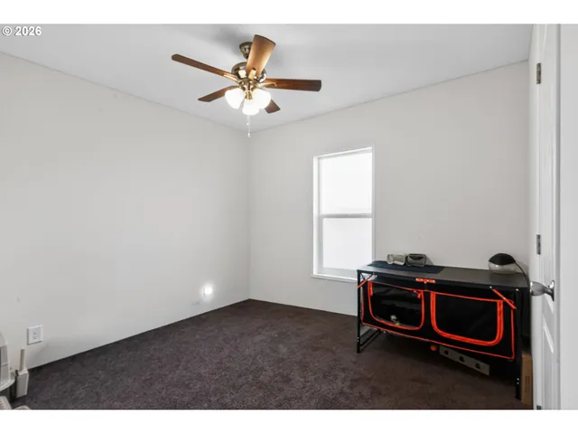 a living room with furniture and a ceiling fan