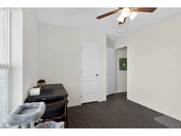 a living room with furniture and a ceiling fan