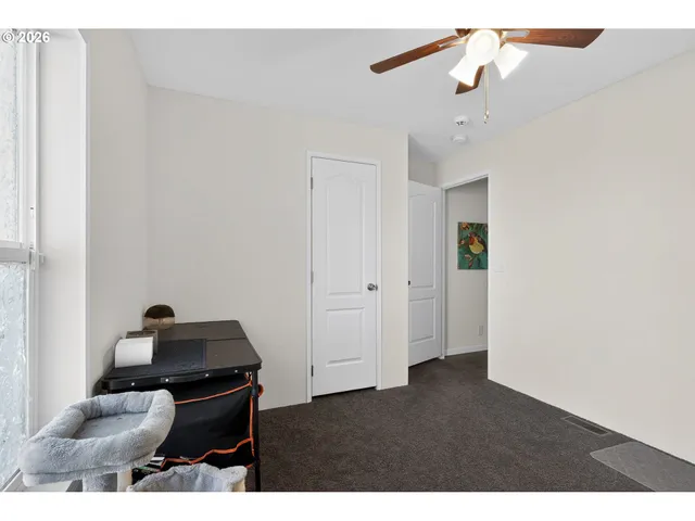 a living room with furniture and a ceiling fan