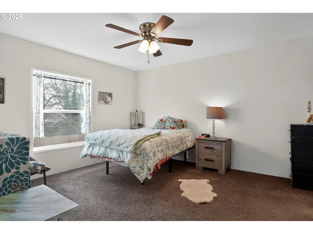 a bed room with bed and a window