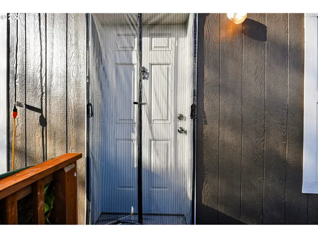 a bathroom with a glass door shower and vanity