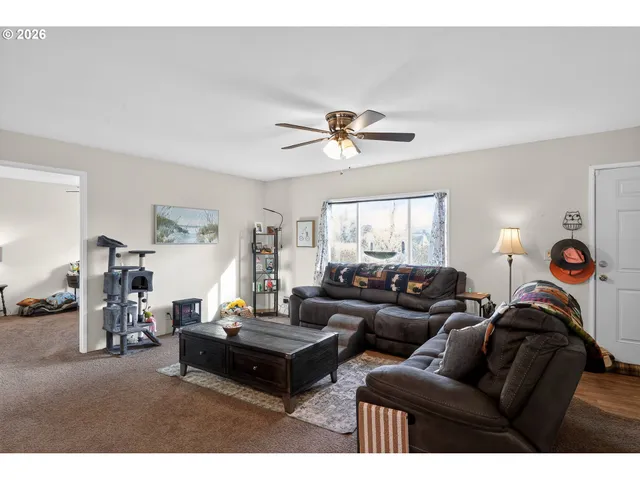 a living room with furniture a chandelier and a window