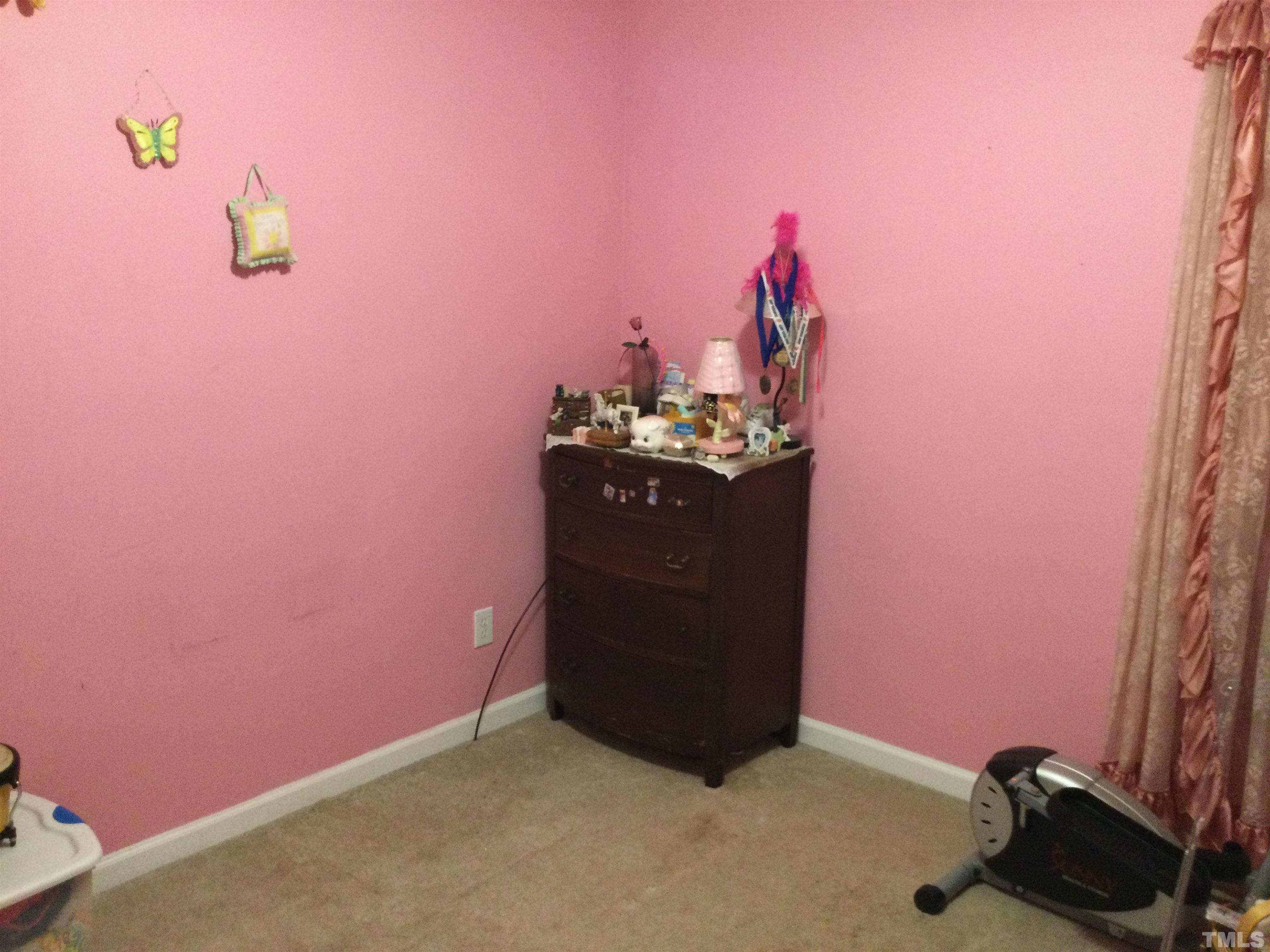 110 Impressive Lane Clayton, NC 27520 - Photo 8 of 14 a room with a mirror and a potted plant