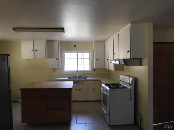 a kitchen with a stove and a refrigerator