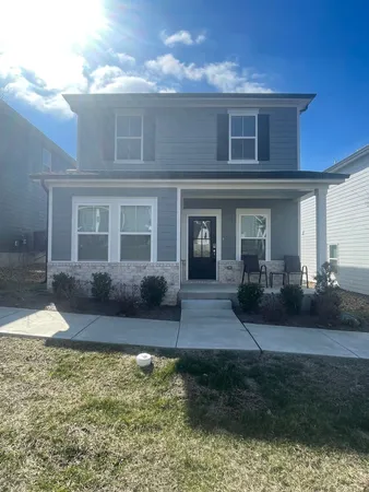 a front view of a house with garden