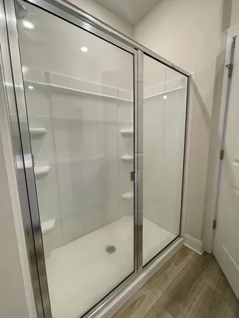a bathroom with a glass shower door