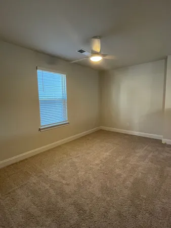 an empty room with a empty space and windows