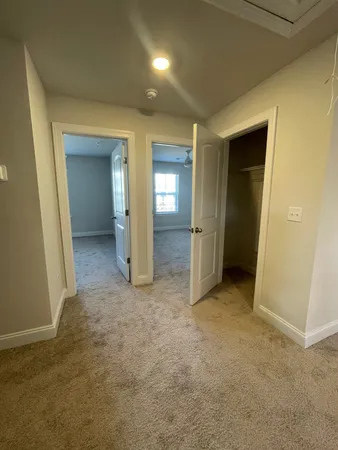 an empty room with closet and mirror