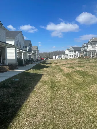 a view of a house with a yard and lake view