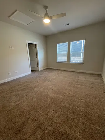 an empty room with windows and closet