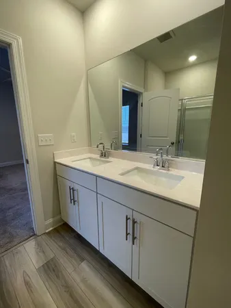 a bathroom with a double vanity sink and mirror