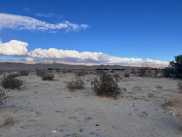 2-15 30th Avenue Thousand Palms, CA 92276 - Photo 4 of 7 a view of a dry field with trees in the background