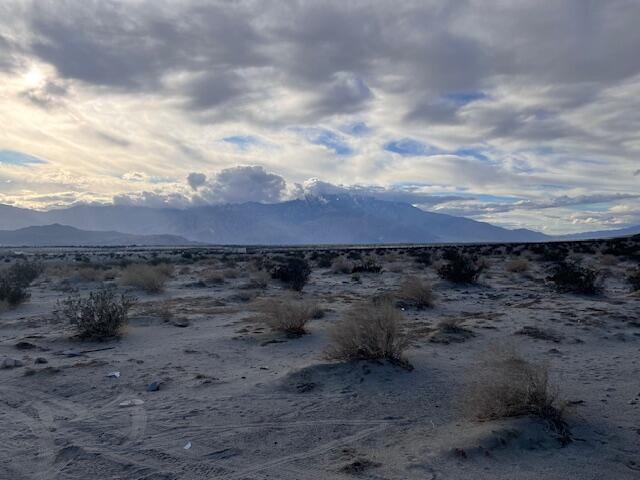 2-15 30th Avenue Thousand Palms, CA 92276 - Photo 6 of 7 a view of a dry field with trees in the background