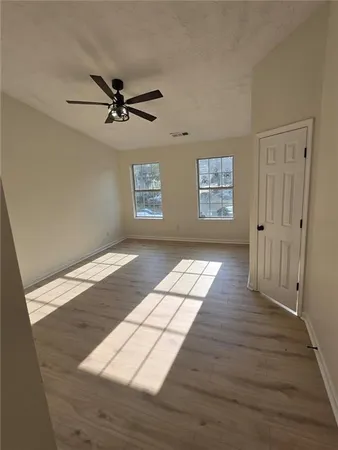wooden floor in an empty room with a window