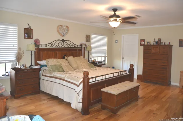 a bed sitting in a spacious bedroom next to a window