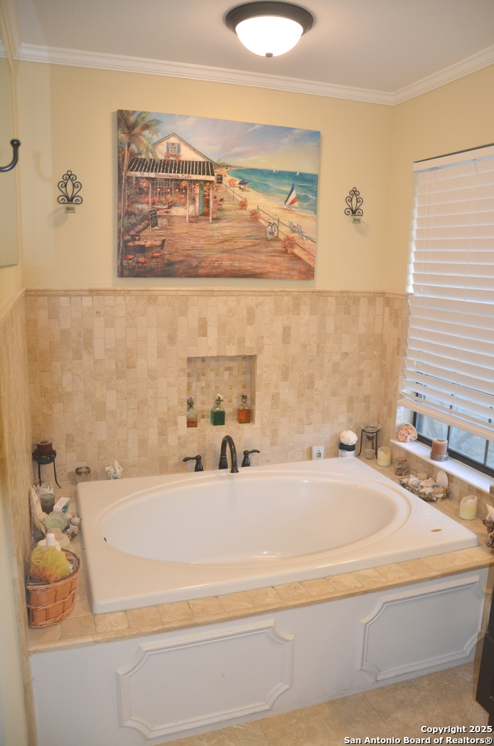 1219 County Road 761 Devine, TX 78016 - Photo 13 of 31 a bathroom with a bathtub and a sink