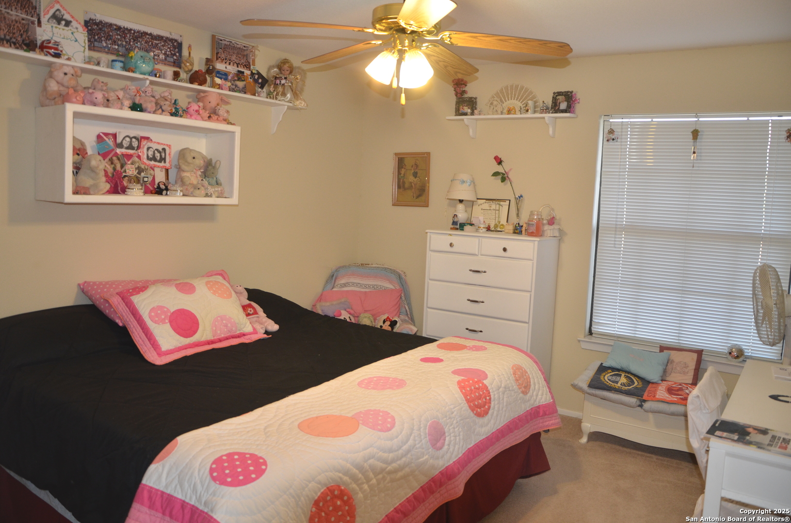 1219 County Road 761 Devine, TX 78016 - Photo 16 of 31 a bedroom with a bed and a chandelier