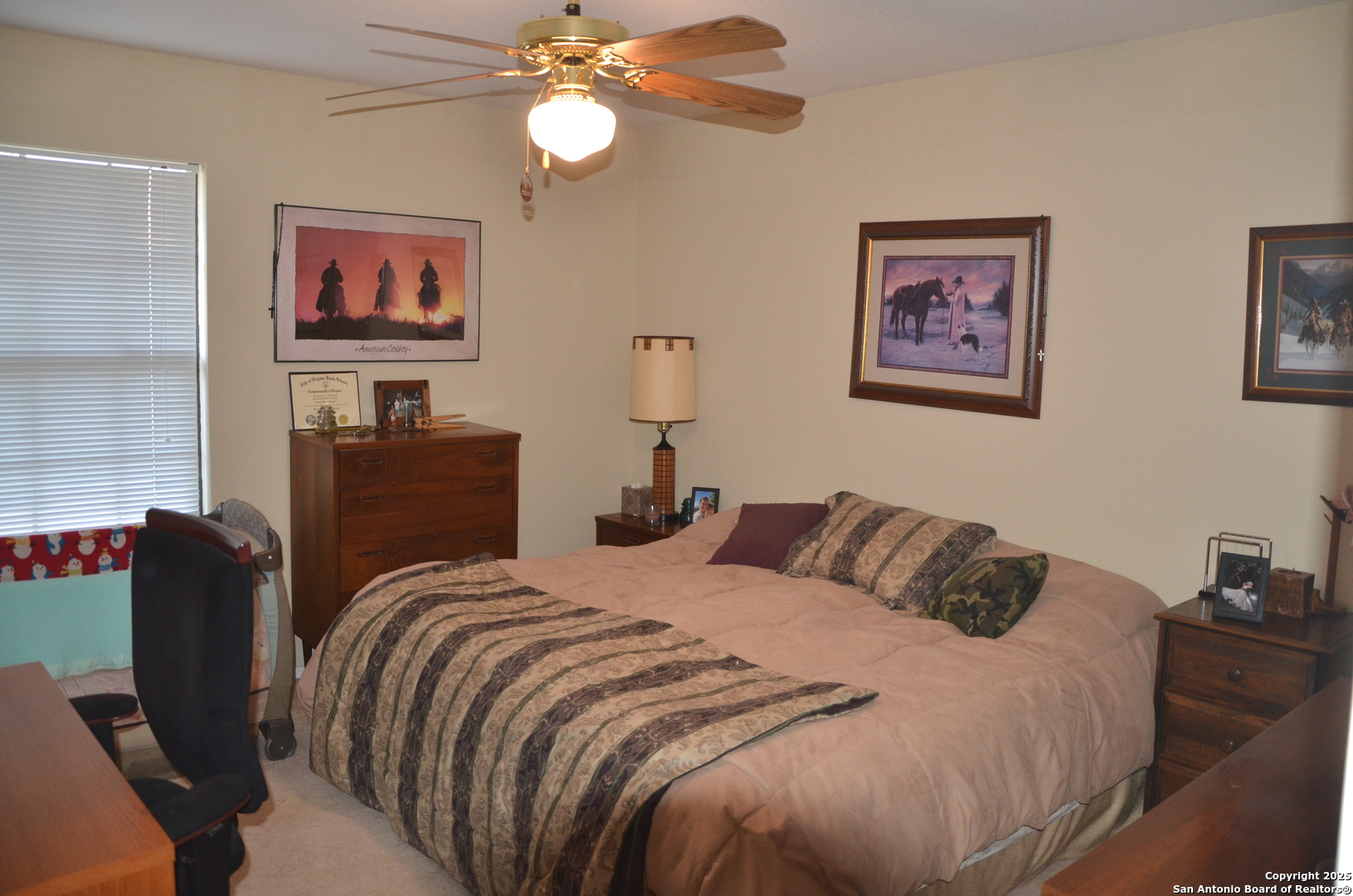 1219 County Road 761 Devine, TX 78016 - Photo 17 of 31 a bedroom with bed and a chair