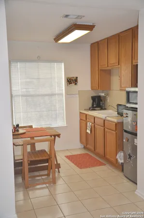 a kitchen with a stove a sink and a window