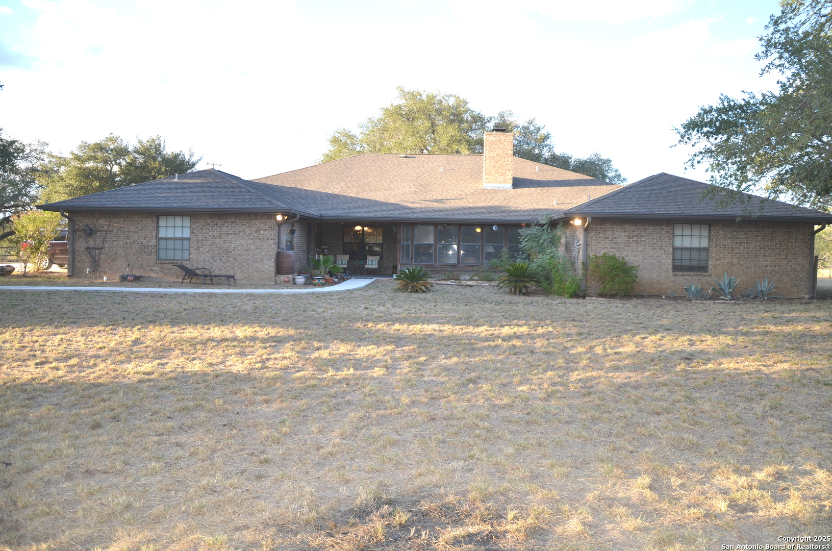 1219 County Road 761 Devine, TX 78016 - Photo 22 of 31 a front view of a house with a yard