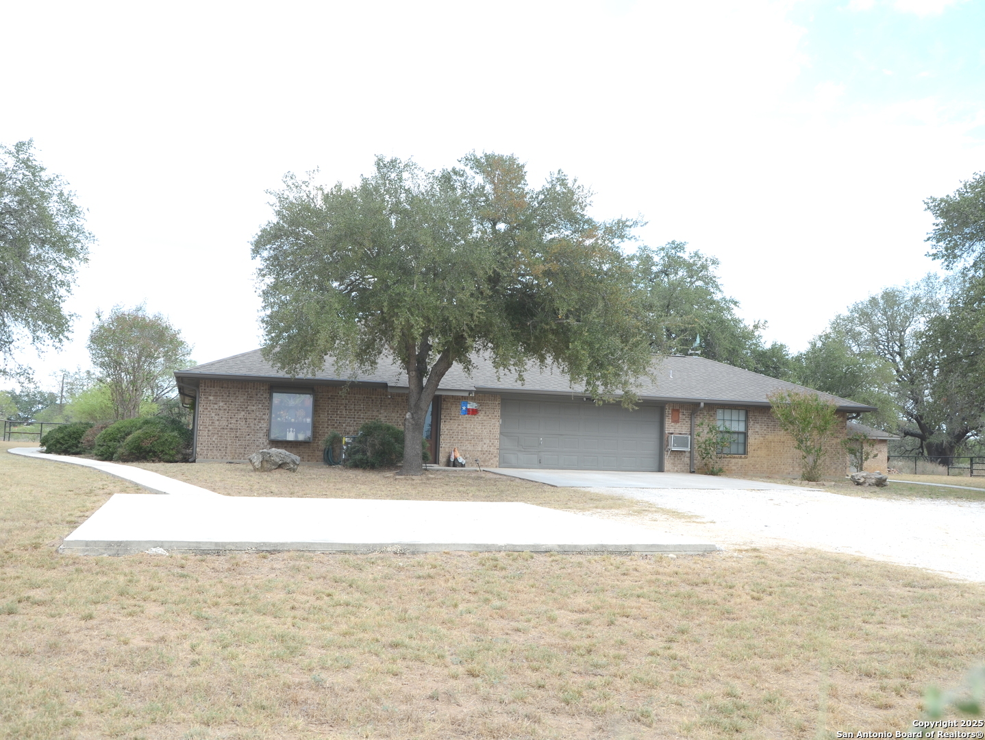 1219 County Road 761 Devine, TX 78016 - Photo 3 of 31 a swimming pool with outdoor seating and yard