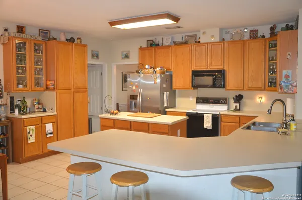 a kitchen with stainless steel appliances a sink and a stove